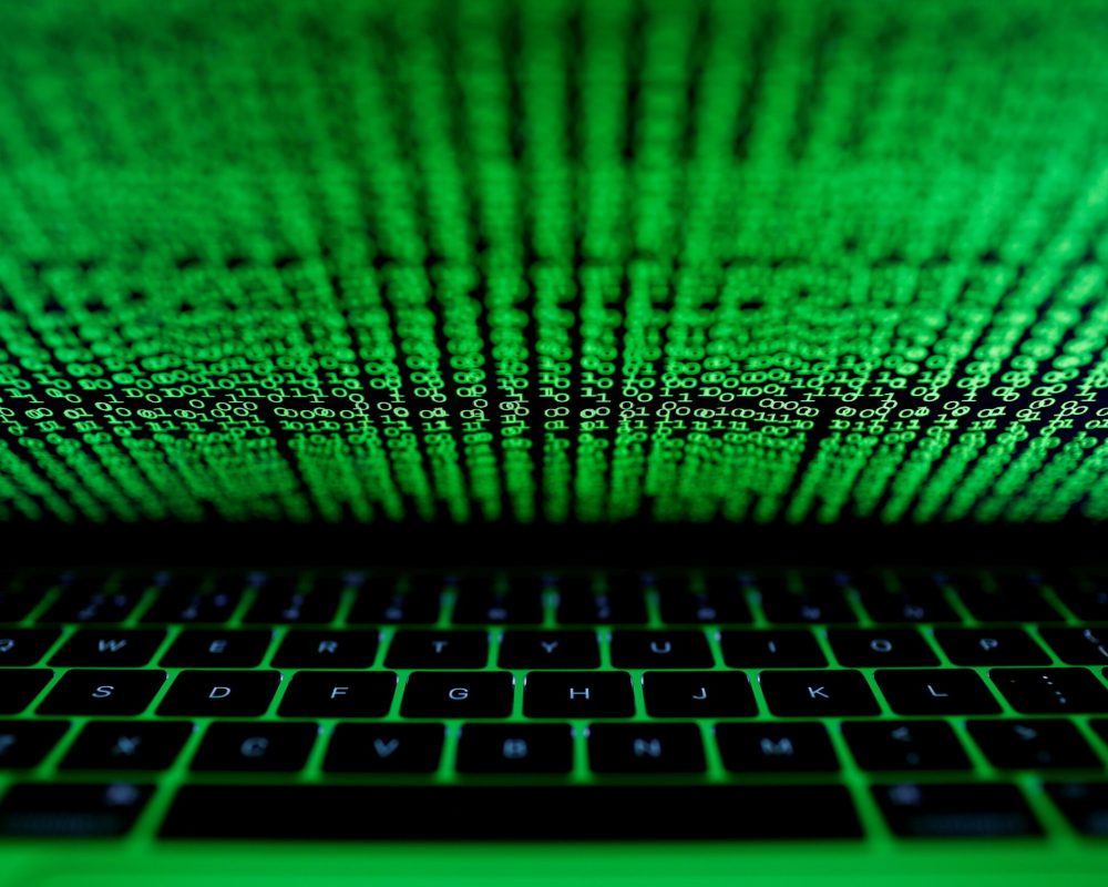 FILE PHOTO: A computer keyboard lit by a displayed cyber code is seen in this illustration picture taken on March 1,  2017. REUTERS/Kacper Pempel/File Photo